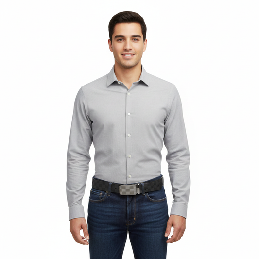 Man wearing a light gray dress shirt and dark jeans on a white background