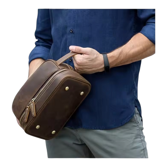 Person holding a brown leather bag against a white background
