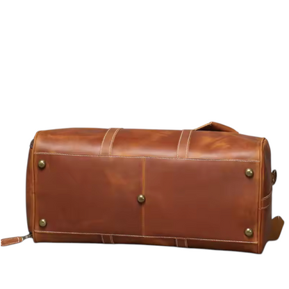 Brown leather duffel bag with studs on a white background