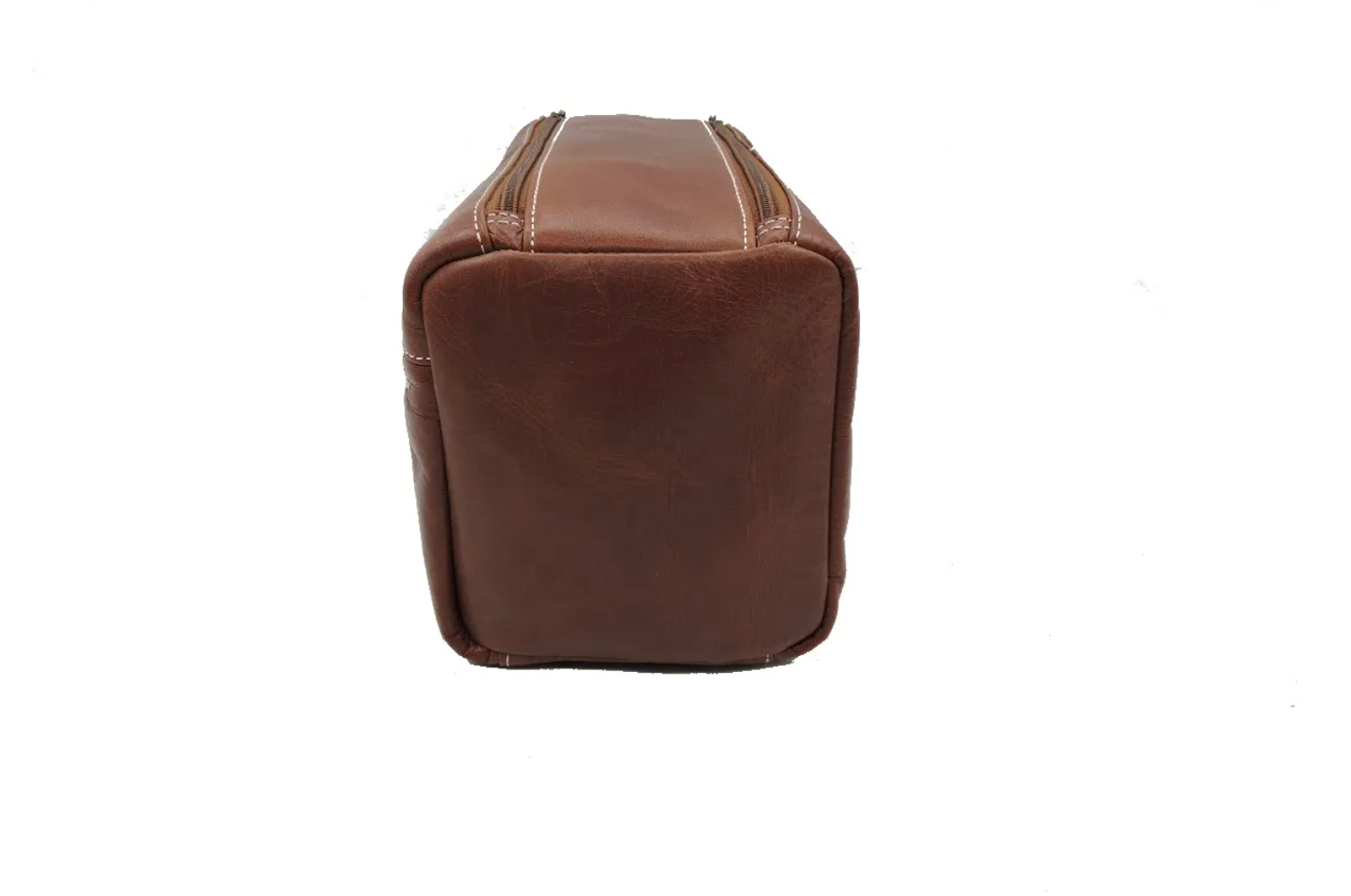 Side view of a brown leather toiletry bag on a white background