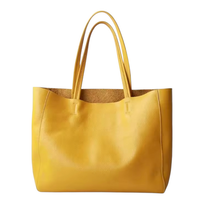 Front view of a yellow leather tote bag on a white background