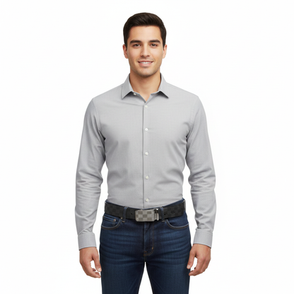 Man wearing a light gray dress shirt and dark jeans on a white background