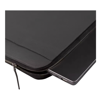 Close up view of black leather laptop sleeve with a zipper on a white background