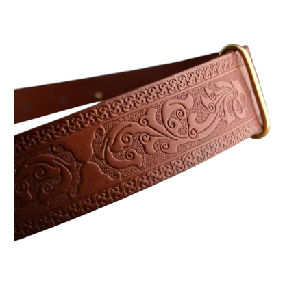 Brown leather belt with intricate embossed design on a white background
