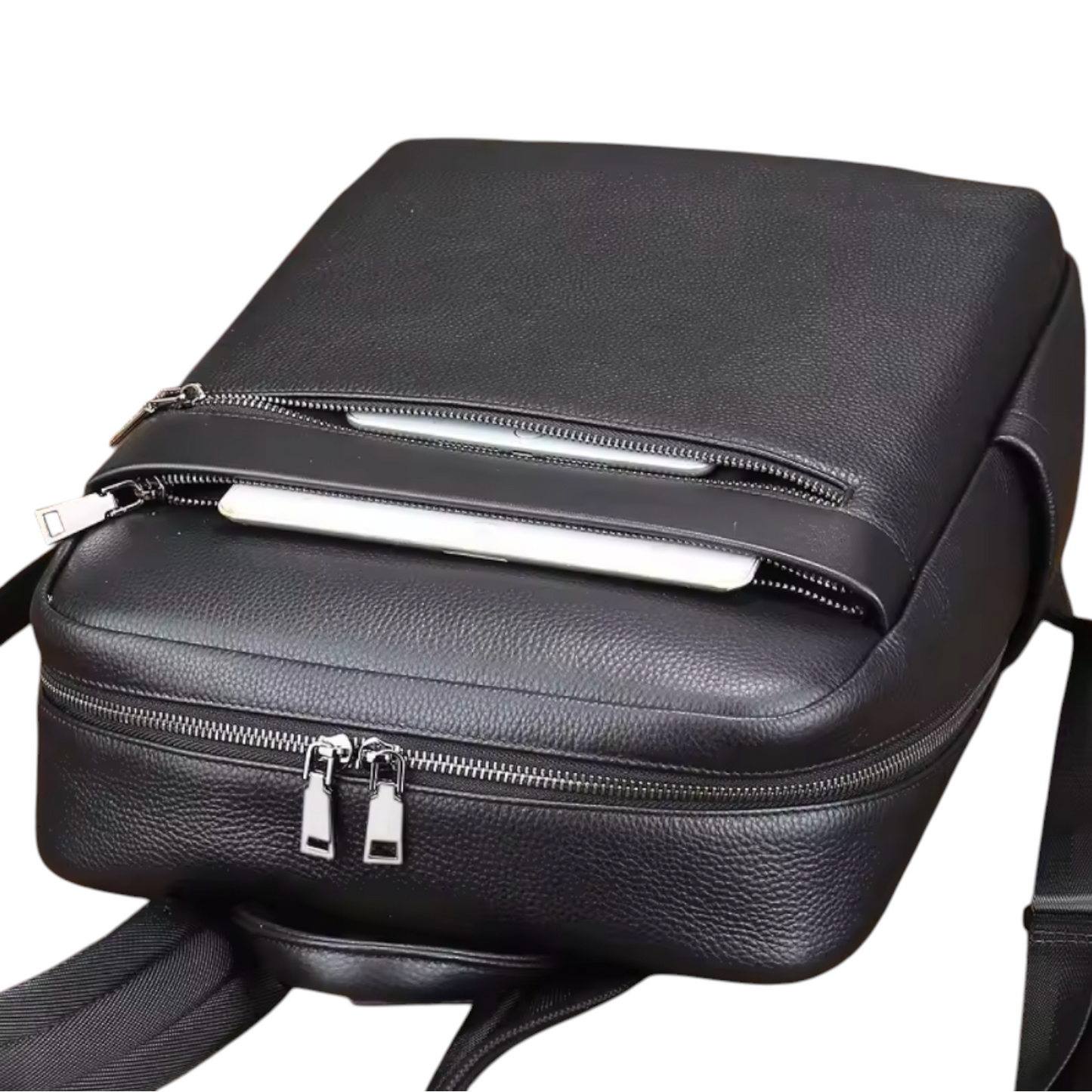 Close up view of a black leather backpack with zippers on a white background