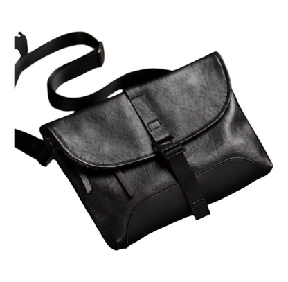 Front view of a black leather bag with a strap on a white background
