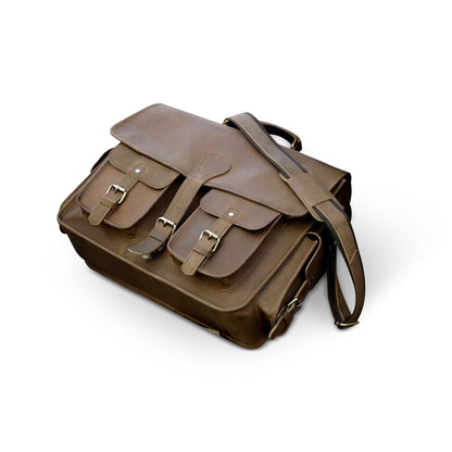 Side view of a Brown leather messenger bag on a white background