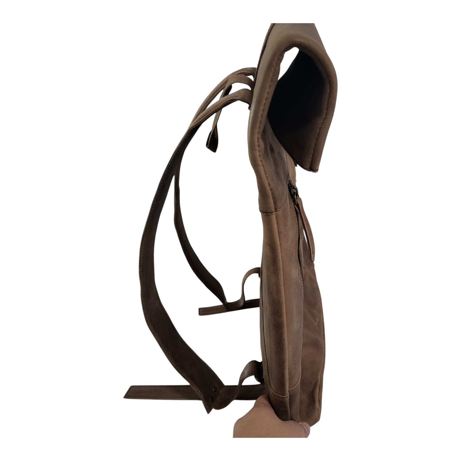 Side view of a brown leather backpack on a white background